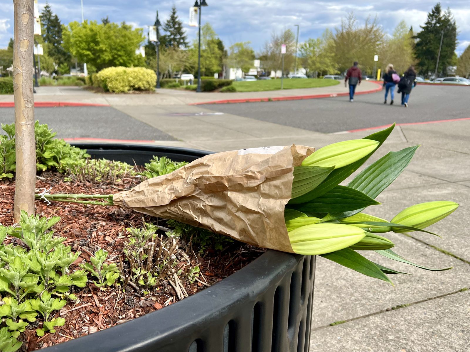 A bouquet of flowers rests near the entrance to Southridge High School in Beaverton on Wednesday, April 27, 2022.