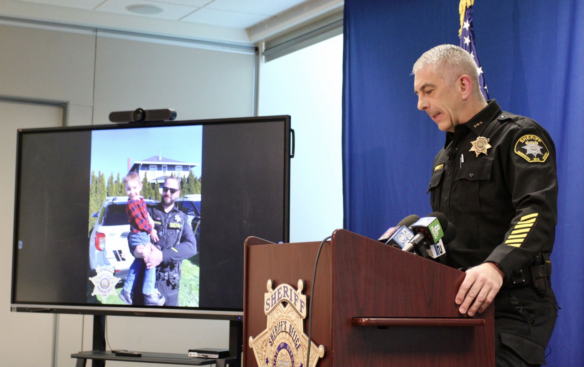 Washington County Sheriff Pat Garrett called for a moment of silence while displaying a photo of critically-injured deputy Michael Trotter during a press conference on Wednesday, April 27, 2022.