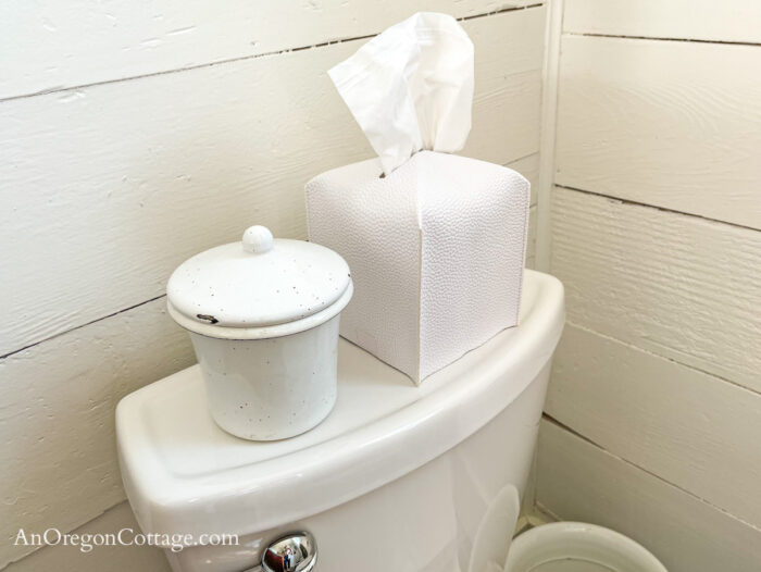 leather like white tissue box cover on toilet back
