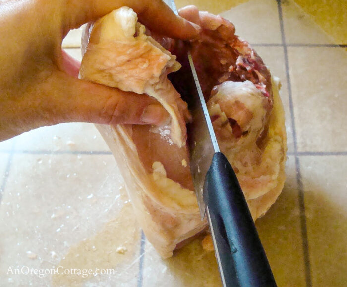 how to cut whole raw chicken-cut breast from back