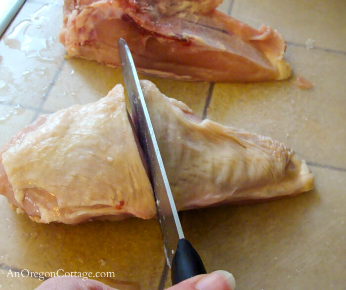 cutting whole chicken-cutting breasts in half
