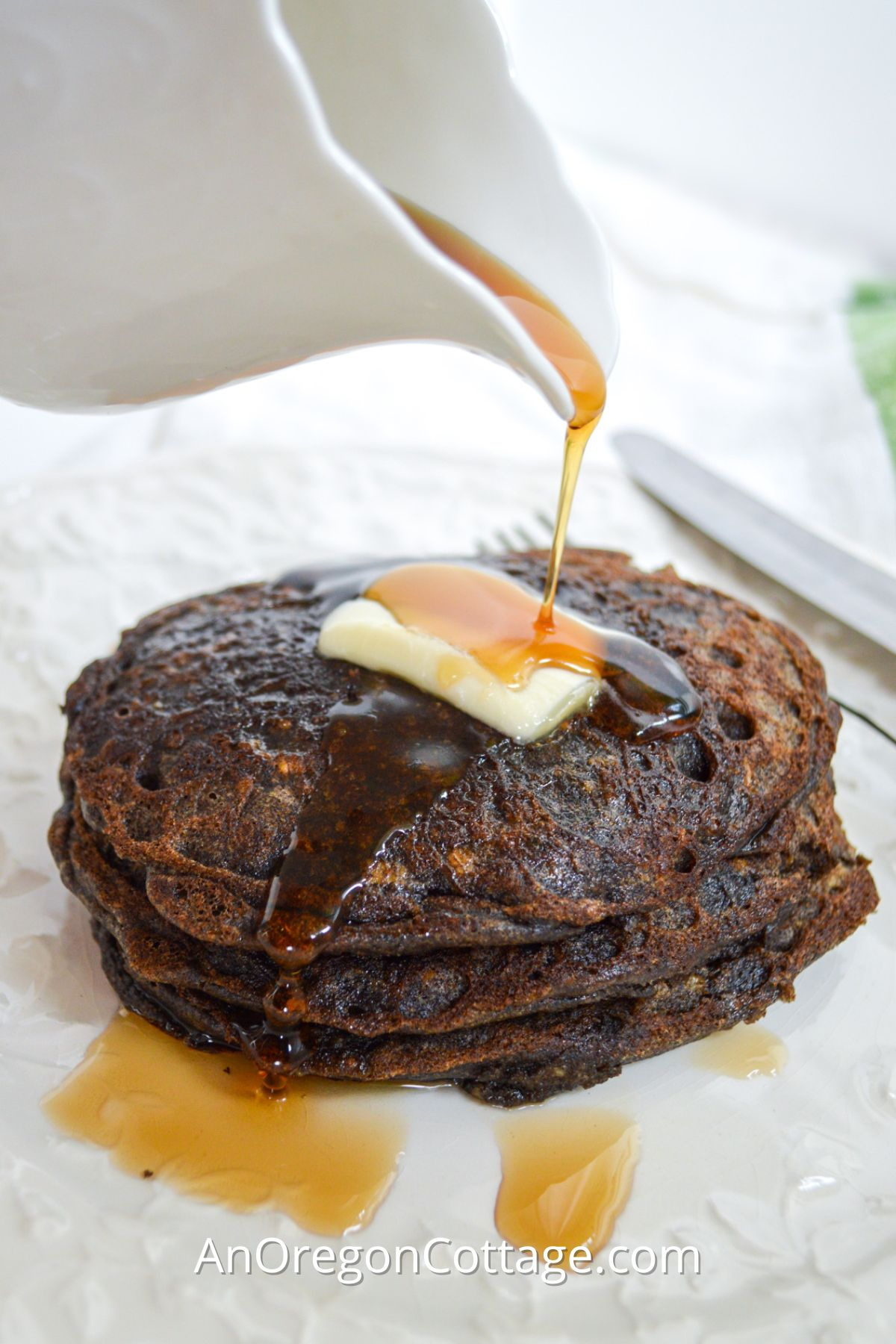 pouring syrup on buckwheat pancakes