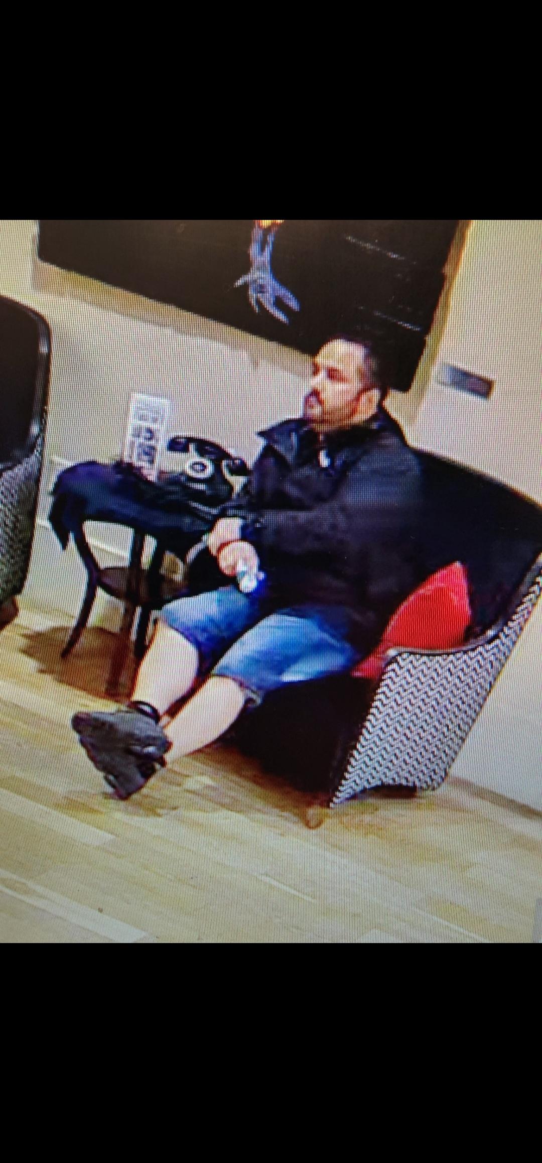 Photo of Joe Harker in a chair, on surveillance footage