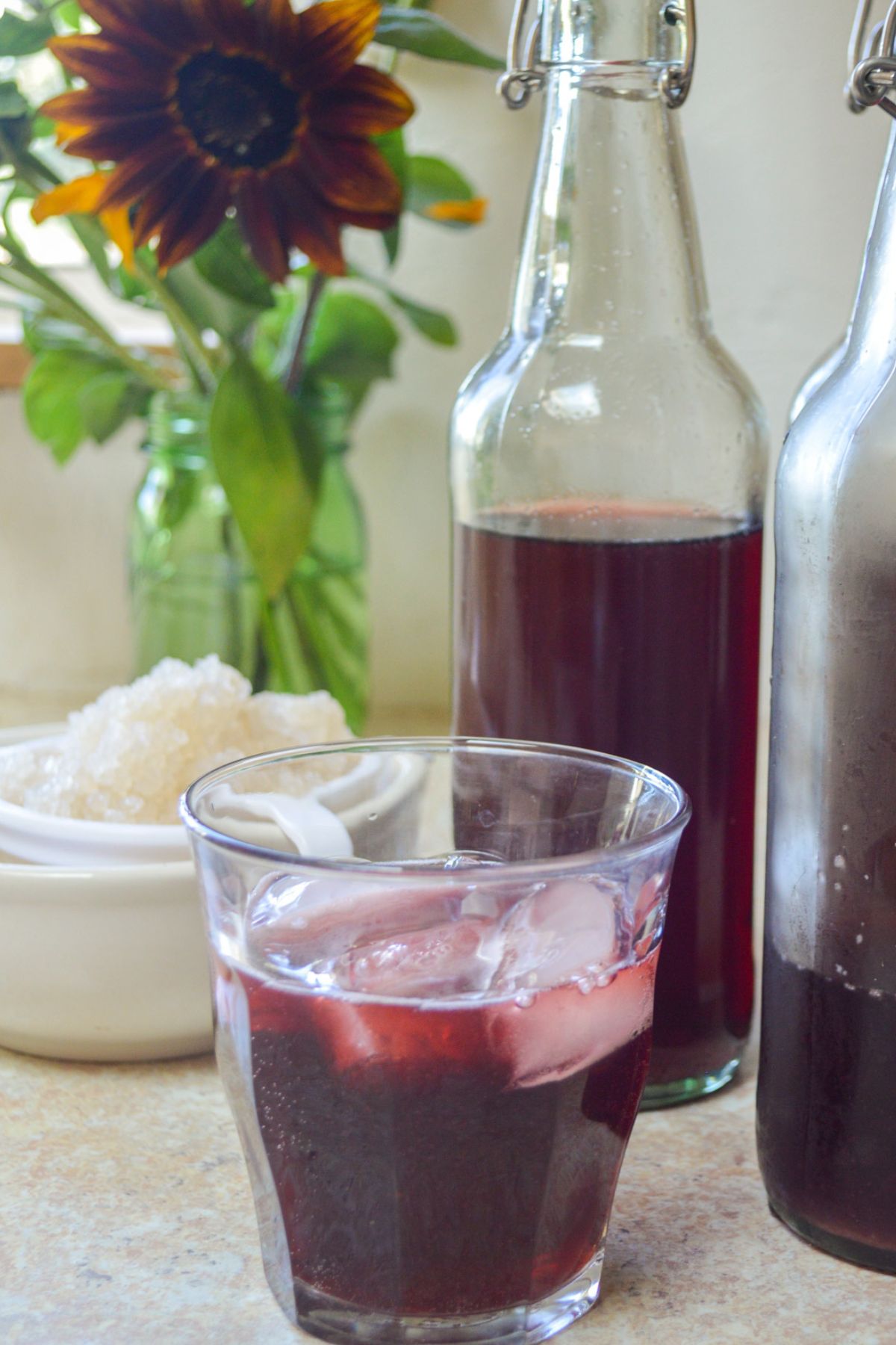 cherry water kefir in glass with bottles