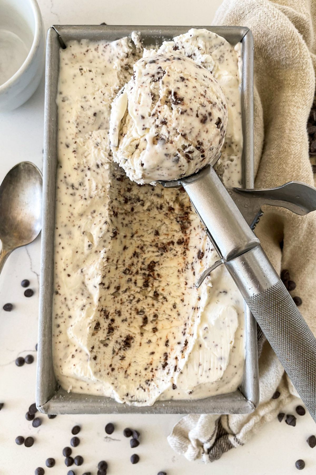 scooping no-churn chocolate ice cream from loaf pan