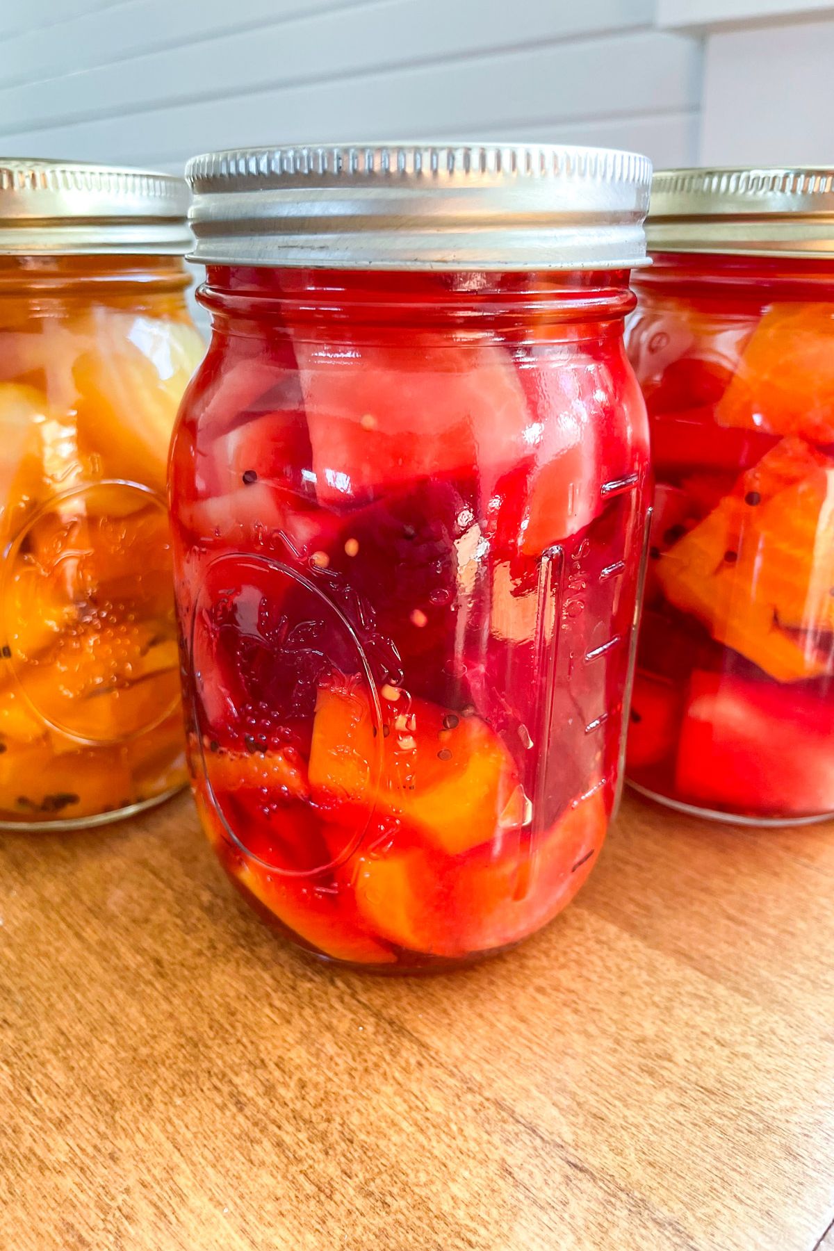 sliced pickled beets in jars on counter