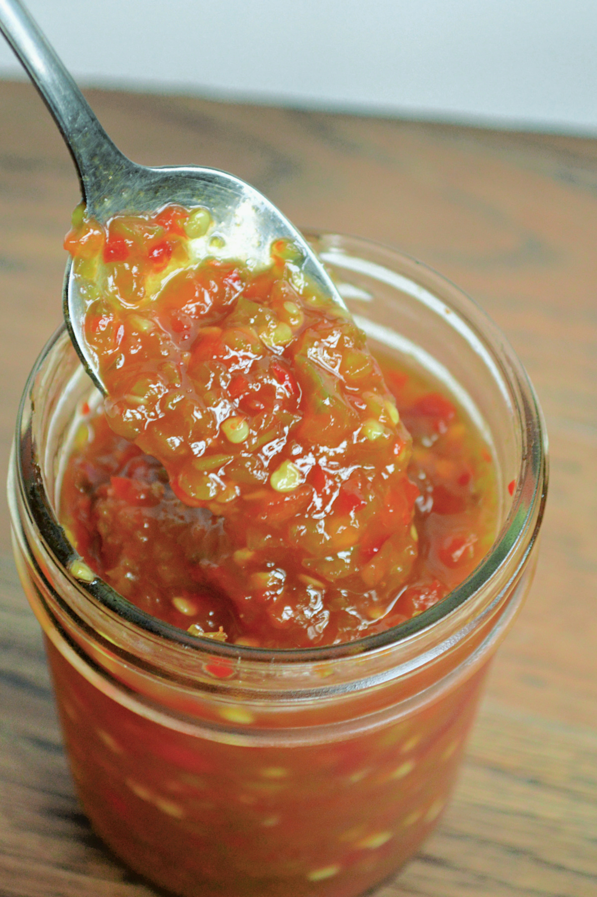 pepper jelly on spoon in jar