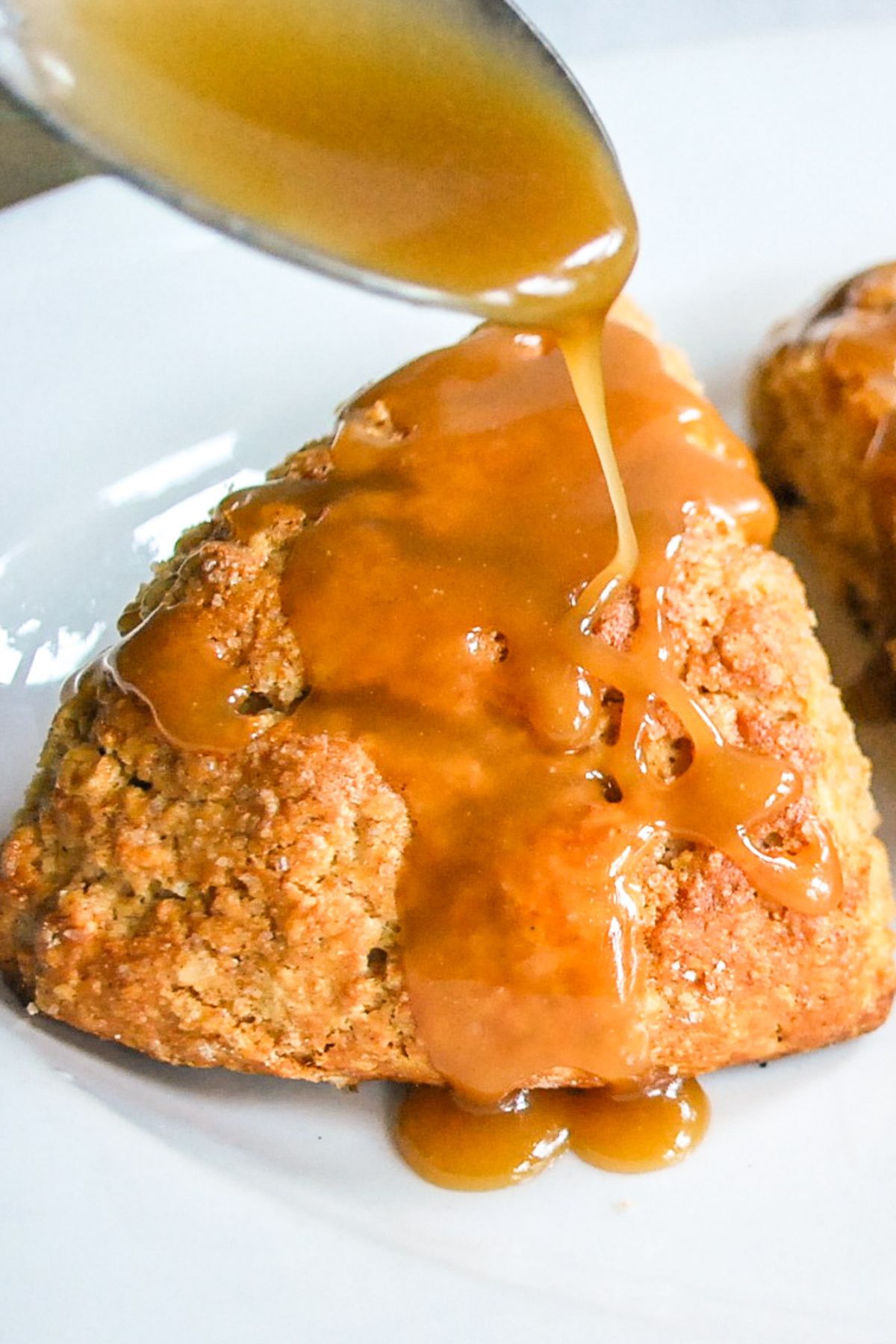 drizzling caramel sauce on apple scone