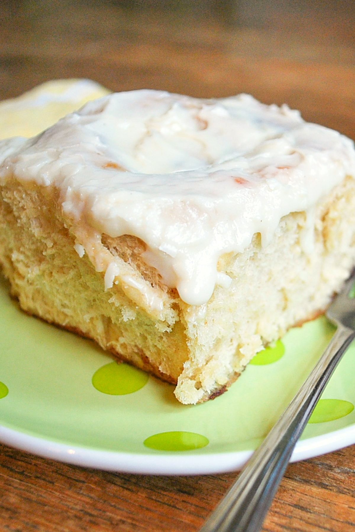 frosted cinnamon roll on green plate