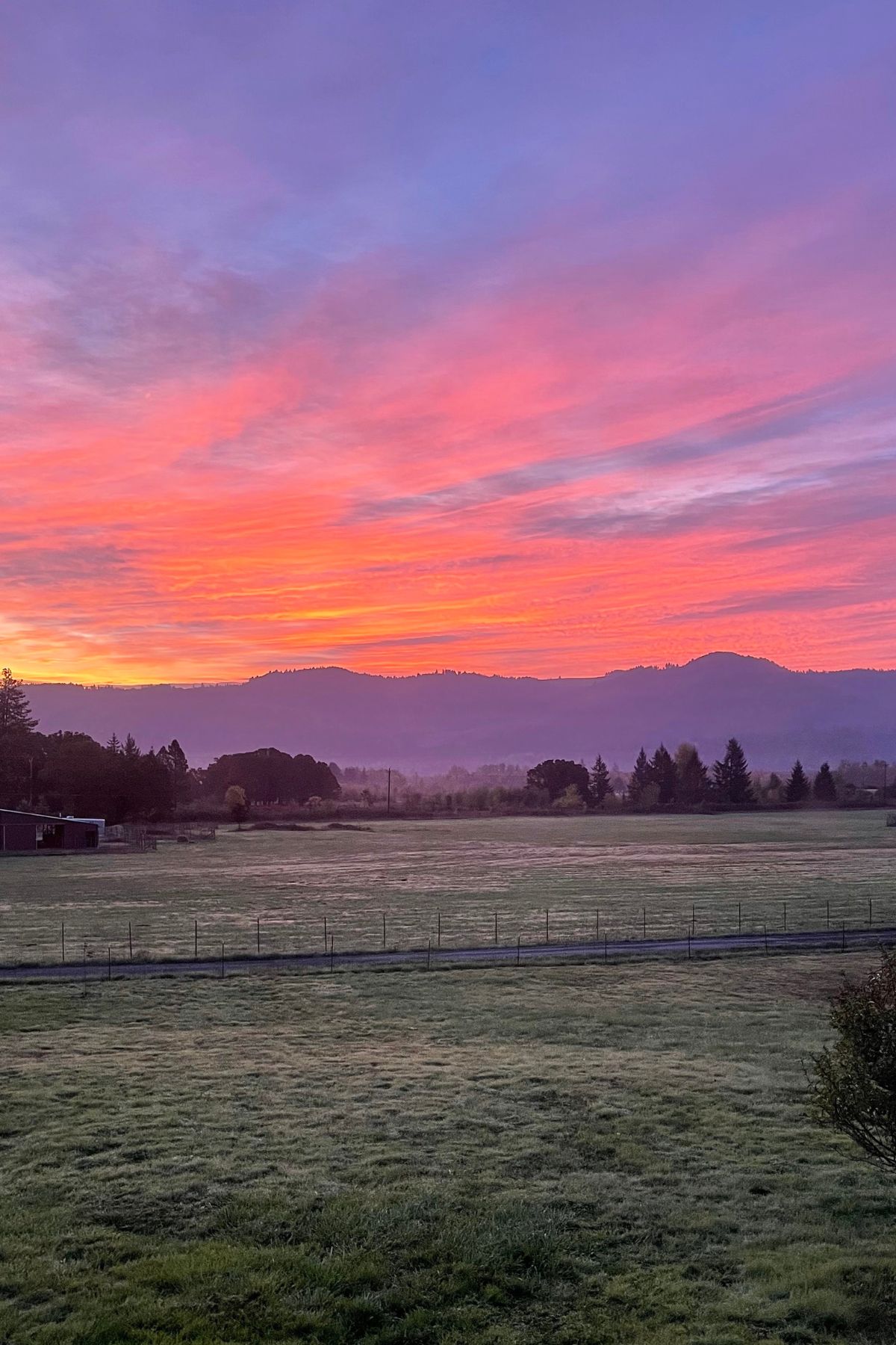 pink-orange sunrise over the hills
