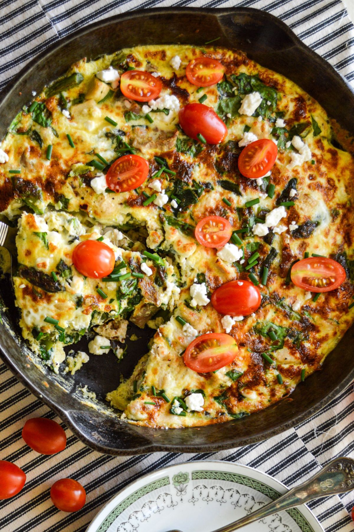 chicken and spinach frittata in cast iron pan above