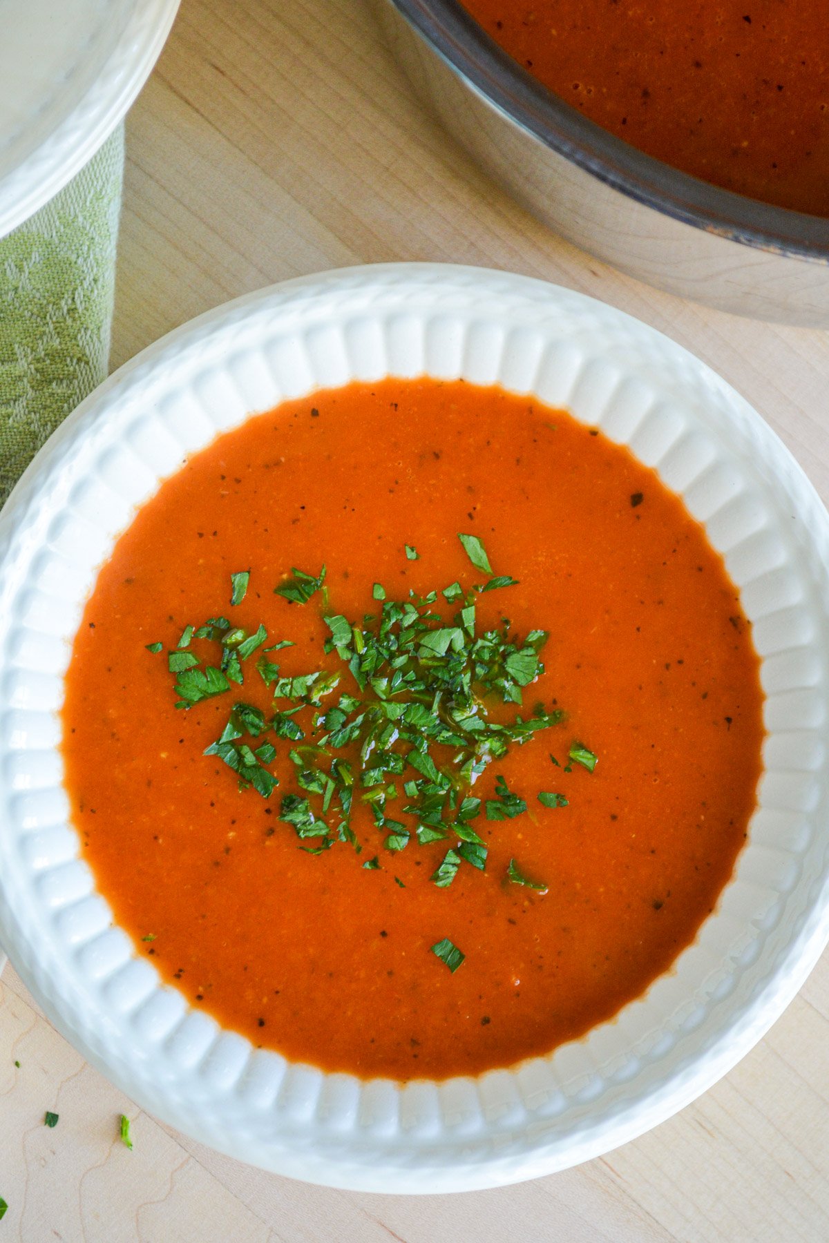 tomato soup in white bowl above