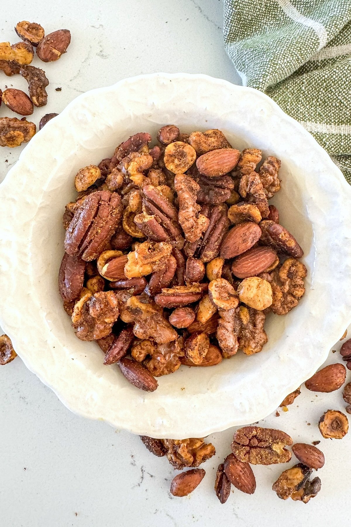spiced nuts in a white bowl from above